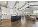 Open-concept kitchen with white cabinetry, island, stainless steel appliances, and hardwood floors at 1905 Cedar Dam Ln, Wendell, NC 27591