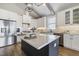 Bright kitchen with white cabinets, quartz countertops, stainless steel appliances, and large center island at 1905 Cedar Dam Ln, Wendell, NC 27591