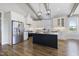 Bright kitchen with white cabinets, quartz countertops, stainless steel appliances, and large center island at 1905 Cedar Dam Ln, Wendell, NC 27591