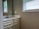 Clean bathroom with neutral-toned vanity and large mirror at 194 Cornfield Ln, Benson, NC 27504