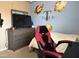 Comfortable bedroom space with sports decor and a mounted television at 194 Cornfield Ln, Benson, NC 27504