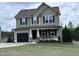 Charming two-story home with a covered front porch and well-maintained lawn at 194 Cornfield Ln, Benson, NC 27504