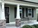 Inviting front porch with stone accents and outdoor seating area at 194 Cornfield Ln, Benson, NC 27504