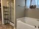 Bright bathroom featuring a large soaking tub and glass shower for the ultimate convenience at 194 Cornfield Ln, Benson, NC 27504