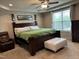 Spacious main bedroom featuring a tray ceiling, ceiling fan and a large window for natural light at 194 Cornfield Ln, Benson, NC 27504