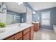 Well-lit bathroom featuring double vanity sinks, a large mirror, and tile flooring at 2001 Lilly Brook St, Fuquay Varina, NC 27526