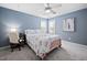 Bright bedroom with a bed, desk, and a ceiling fan, perfect for work or relaxation at 2001 Lilly Brook St, Fuquay Varina, NC 27526