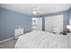 Bright bedroom features a ceiling fan, double closet, and a pleasant blue paint color at 2001 Lilly Brook St, Fuquay Varina, NC 27526