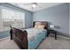 Cozy bedroom with a full-sized bed, side table, and window for natural light at 2001 Lilly Brook St, Fuquay Varina, NC 27526