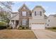Charming two-story home featuring a stone facade, covered porch, and a well-manicured front yard at 2001 Lilly Brook St, Fuquay Varina, NC 27526