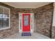 Front porch view with stone facade and a welcoming red front door at 2001 Lilly Brook St, Fuquay Varina, NC 27526