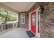 Front porch view with stone facade and a welcoming red front door at 2001 Lilly Brook St, Fuquay Varina, NC 27526