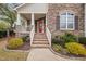 Charming home exterior with a stone facade and a welcoming red front door at 2001 Lilly Brook St, Fuquay Varina, NC 27526