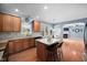 Open kitchen with wood cabinets, an island and view of breakfast nook at 2001 Lilly Brook St, Fuquay Varina, NC 27526