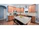 Kitchen with stainless steel appliances, island with seating, and plenty of cabinet space at 2001 Lilly Brook St, Fuquay Varina, NC 27526