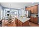Open kitchen with wood cabinets, an island and view of breakfast nook and living room at 2001 Lilly Brook St, Fuquay Varina, NC 27526