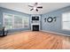 Bright living room with hardwood floors, fireplace, and large windows at 2001 Lilly Brook St, Fuquay Varina, NC 27526