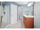 Bathroom with a wooden vanity, framed mirror, and glass-enclosed shower at 2001 Lilly Brook St, Fuquay Varina, NC 27526