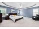 Spacious main bedroom with tray ceiling, ceiling fan, and large windows for ample natural light at 2001 Lilly Brook St, Fuquay Varina, NC 27526