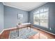 Bright office space with hardwood floors, accent rug, and large window providing natural light at 2001 Lilly Brook St, Fuquay Varina, NC 27526