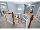 Bright foyer staircase with hardwood railing, white spindles, and decorative chandelier at 2001 Lilly Brook St, Fuquay Varina, NC 27526
