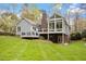 Expansive backyard featuring a deck, patio and a glass enclosed sunroom providing ample space for activities at 2321 Mica Mine Ln, Wake Forest, NC 27587