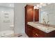 Well lit bathroom featuring a granite countertop, and a glass enclosed shower with seat at 2321 Mica Mine Ln, Wake Forest, NC 27587