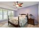 Bedroom featuring carpeted floor, ceiling fan, and ample natural light from large windows at 2321 Mica Mine Ln, Wake Forest, NC 27587