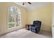 Cozy bedroom featuring a large arched window and reading chair at 2321 Mica Mine Ln, Wake Forest, NC 27587