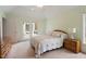 Bright bedroom with carpet flooring, a quilt, and a door that leads to an outside patio at 2321 Mica Mine Ln, Wake Forest, NC 27587