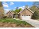 Charming brick home featuring an attached two-car garage and lush landscaping, perfect for curb appeal at 2321 Mica Mine Ln, Wake Forest, NC 27587
