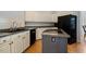 Efficient kitchen with white cabinetry and black appliances at 2321 Mica Mine Ln, Wake Forest, NC 27587
