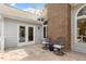 Inviting outdoor patio with tiled flooring and comfortable seating, perfect for relaxation and outdoor gatherings at 2321 Mica Mine Ln, Wake Forest, NC 27587