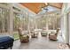 Bright sunroom with multiple windows, a wood ceiling, tile floors, and four armchairs providing a relaxing space at 2321 Mica Mine Ln, Wake Forest, NC 27587