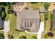 Aerial view of the property with a landscaped backyard and a paved patio area with an outdoor fireplace at 2421 Trenton Park Ln, Raleigh, NC 27607