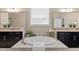 Elegant bathroom with dual vanities, a soaking tub, and decorative mirrors at 2421 Trenton Park Ln, Raleigh, NC 27607