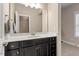 Bathroom featuring a large vanity, framed mirror, updated fixtures, and modern lighting at 2421 Trenton Park Ln, Raleigh, NC 27607