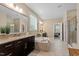 Bright bathroom features a soaking tub, walk-in shower, dual vanity, and neutral tones at 2421 Trenton Park Ln, Raleigh, NC 27607