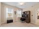 Comfortable bedroom with a built-in desk area, carpeted floor, two windows, and neutral-colored walls at 2421 Trenton Park Ln, Raleigh, NC 27607