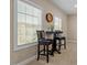 Cozy dining nook featuring a high table and chairs, perfect for casual meals and enjoying the view through the window at 2421 Trenton Park Ln, Raleigh, NC 27607