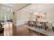 Bright dining room featuring hardwood floors, a chandelier, and modern decor at 2421 Trenton Park Ln, Raleigh, NC 27607