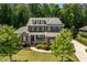 Charming two-story brick home with a manicured front yard and mature trees at 2421 Trenton Park Ln, Raleigh, NC 27607