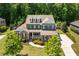Beautiful aerial view of a two-story home with lush landscaping, manicured lawn, and mature trees at 2421 Trenton Park Ln, Raleigh, NC 27607
