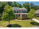 Lovely two-story brick home surrounded by lush greenery and manicured lawn at 2421 Trenton Park Ln, Raleigh, NC 27607