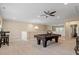 Spacious game room with a pool table, pendant lighting, and a ceiling fan, designed for leisure and relaxation at 2421 Trenton Park Ln, Raleigh, NC 27607
