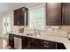 Modern kitchen with stainless dishwasher and sink under a window with granite counters at 2421 Trenton Park Ln, Raleigh, NC 27607