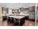 Spacious gourmet kitchen features an island with seating, stainless steel appliances and granite countertops at 2421 Trenton Park Ln, Raleigh, NC 27607