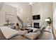 Open living room with fireplace, stairs, and lots of natural light from large windows at 2421 Trenton Park Ln, Raleigh, NC 27607