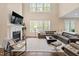 Inviting living room features fireplace, a large sofa and a view of natural light at 2421 Trenton Park Ln, Raleigh, NC 27607