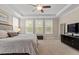 Bright and spacious main bedroom featuring tray ceilings and three large windows at 2421 Trenton Park Ln, Raleigh, NC 27607